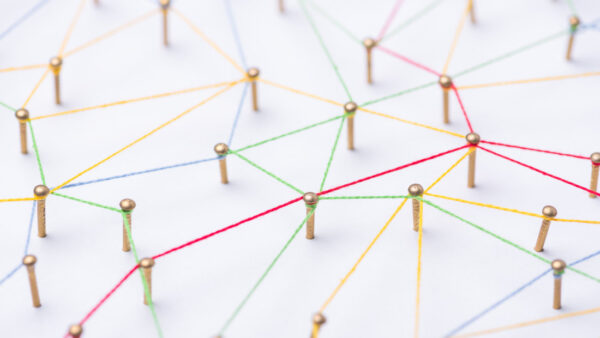 abstract web line connection of color yarn from nail node to node on white background , networking concept