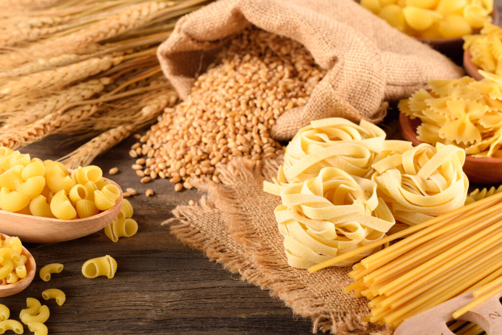 dried pasta and wheat on the wooden board