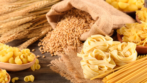dried pasta and wheat on the wooden board