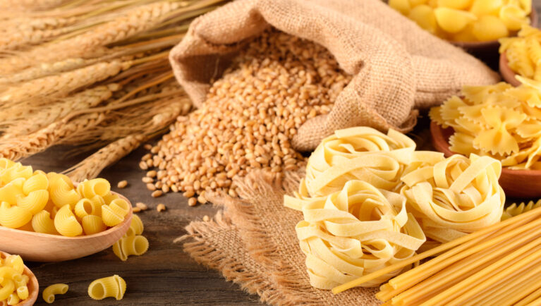 dried pasta and wheat on the wooden board