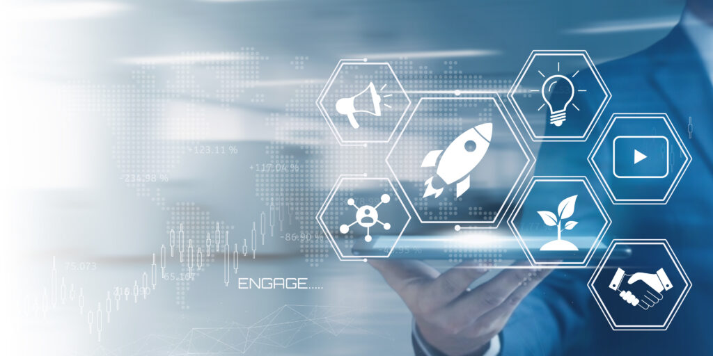 Businessman holding a tablet displaying a futuristic interface with startup and marketing icons representing digital innovation and growth strategies