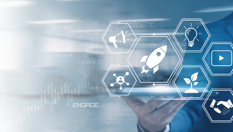 Businessman holding a tablet displaying a futuristic interface with startup and marketing icons representing digital innovation and growth strategies