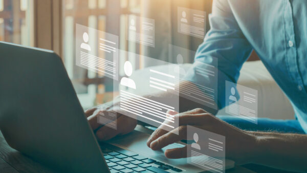 Human resource manager looking at many different cv resume and choosing perfect person to hire. HR concept on virtual screen.