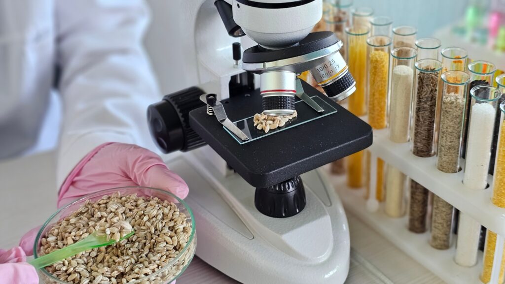 Microscope used to examine seeds with test tubes in laboratory setting