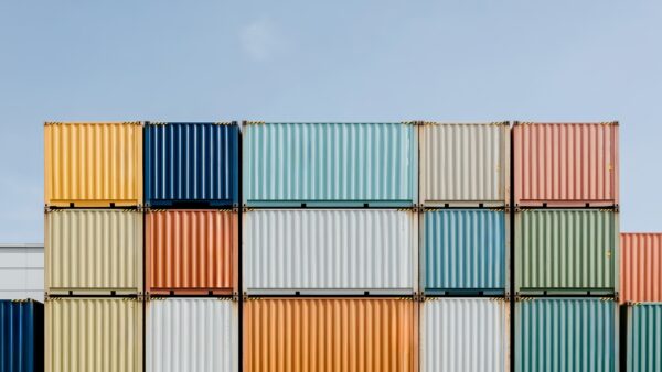 Colorful shipping containers illustrate global trade as the seed industry urges elimination of tariffs on planting seed.