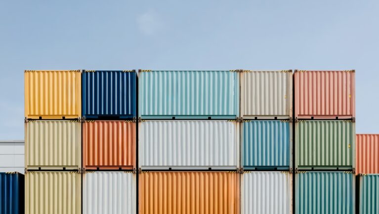 Colorful shipping containers illustrate global trade as the seed industry urges elimination of tariffs on planting seed.
