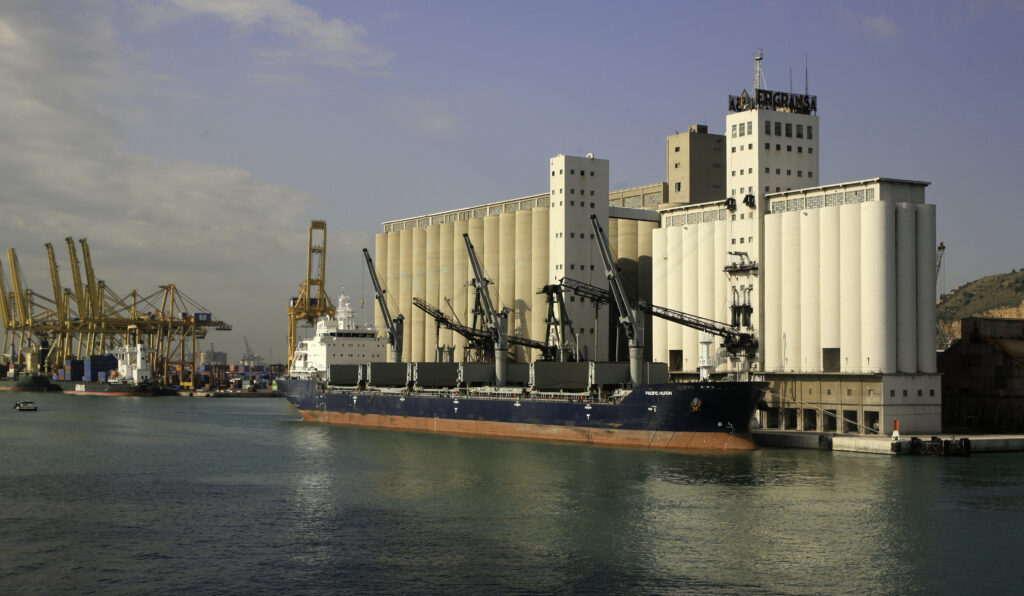 Barcelona, Spain-October 14, 2010: A ship unloading grain into a grain elevator, Bacelon, Spain.