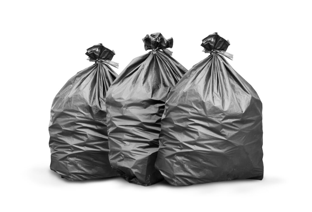 Black trash bag on white background