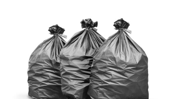 Black trash bag on white background